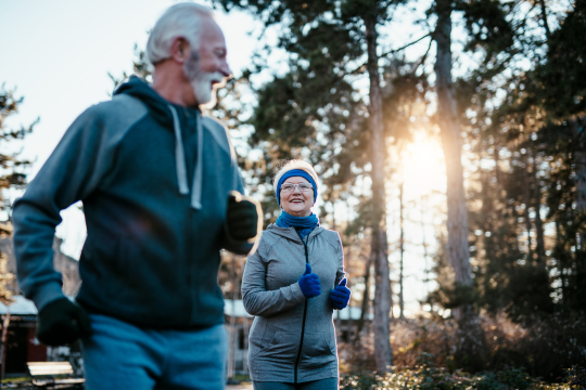 An adult couple enjoying a winter jog.