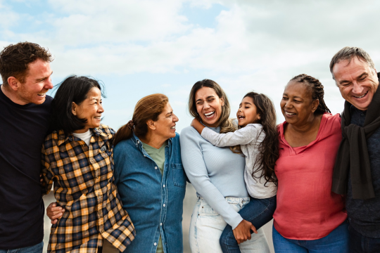 Group of smiling seniors spending time together outside.