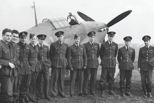 A group of pilots of No. 1 Squadron RCAF, gather in front of a Hawker Hurricane Mark I